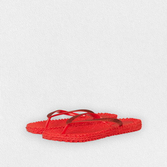 The ILSE JACOBSEN CHEERFUL FLIP FLOP IN DEEP RED by LINES OF DENMARK features woven design and thin dark red straps—perfect lightweight sandals for beach comfort, displayed on a light textured background.