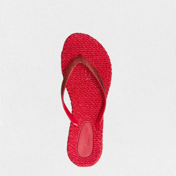 The ILSE JACOBSEN CHEERFUL FLIP FLOP IN DEEP RED by LINES OF DENMARK features woven design and thin dark red straps—perfect lightweight sandals for beach comfort, displayed on a light textured background.