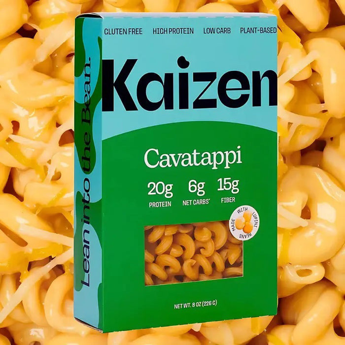 A box of KAIZEN - CAVATAPPI PASTA by KAIZEN FOOD COMPANY is shown with cooked pasta. The label shows it's gluten-free, low carb, plant-based, and has 20g protein, 6g net carbs, and 15g fiber per serving.