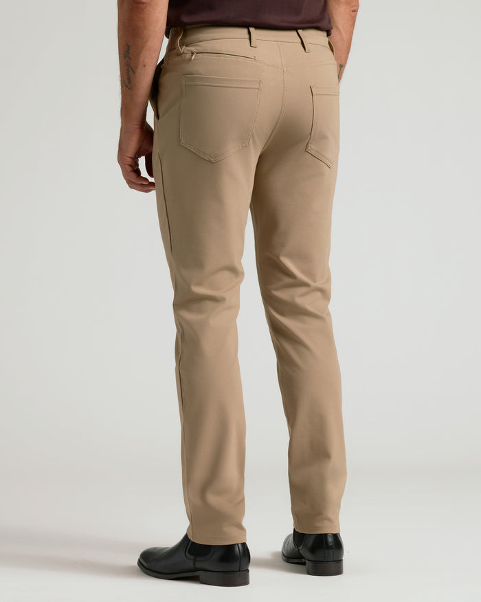 Back view of Khaki Commuter Pants with welted pockets and black shoes.