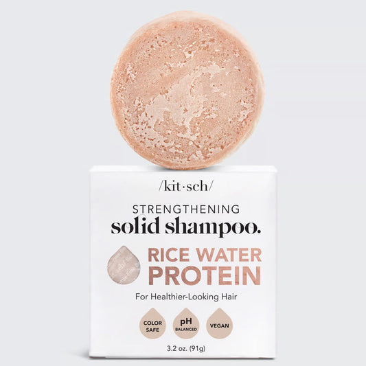 Image of a KITSCH Rice Water Protein Solid Shampoo Bar, featuring a marbled light brown shade. Packaged on a white box labeled for hair growth, it's color-safe, pH balanced, and vegan. Net weight: 3.2 oz (91g).