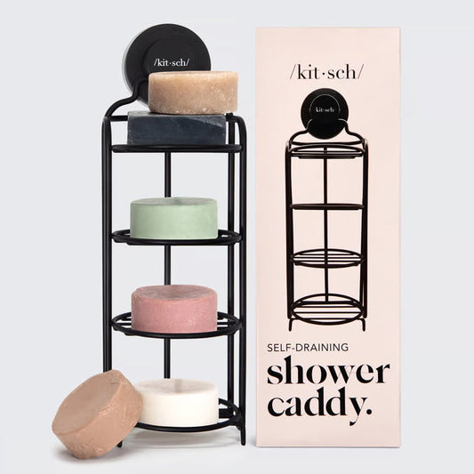 The KITSCH SELF DRAINING SHOWER CADDY, a black metal wall mount organizer, holds five colorful round soaps beside its illustrated packaging. This eco-friendly soap dish is perfect for your bathroom.
