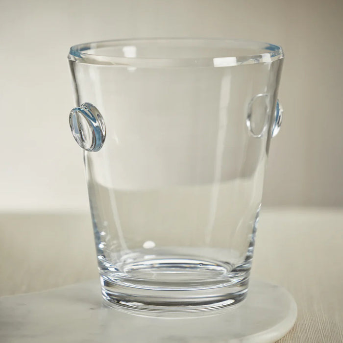 The ZODAX LA SERENA BEVELED GLASS ICE BUCKET stands empty on a white background, featuring clear glass with two small loop handles on opposite sides. Dimensions: 8.5 x 10 inches.