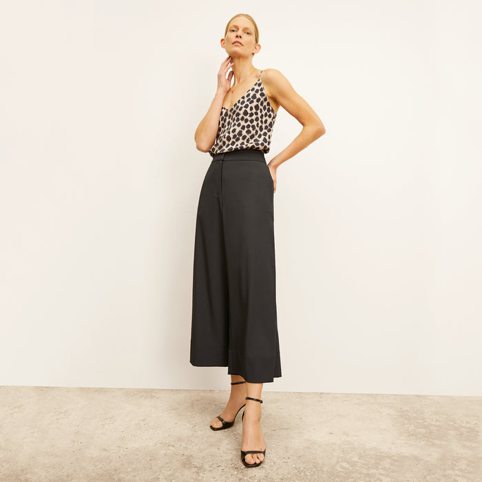 Front image of a woman standing wearing the Lisey Cami—Sahara Print Washable Silk in Tan/Black