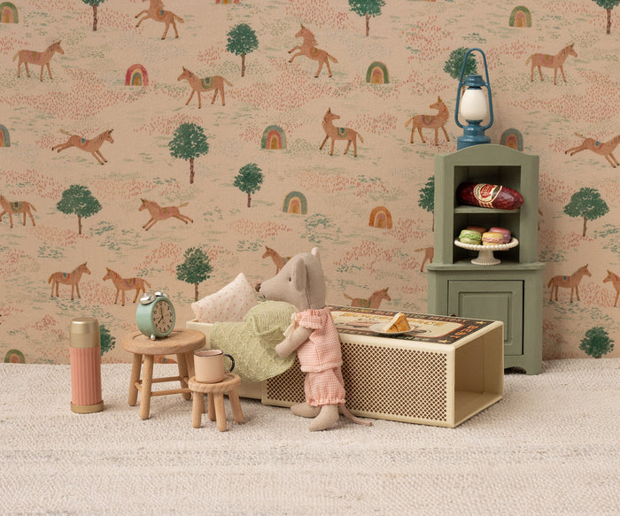 Children's room with toy mouse, furniture, and decorative wallpaper featuring animals.