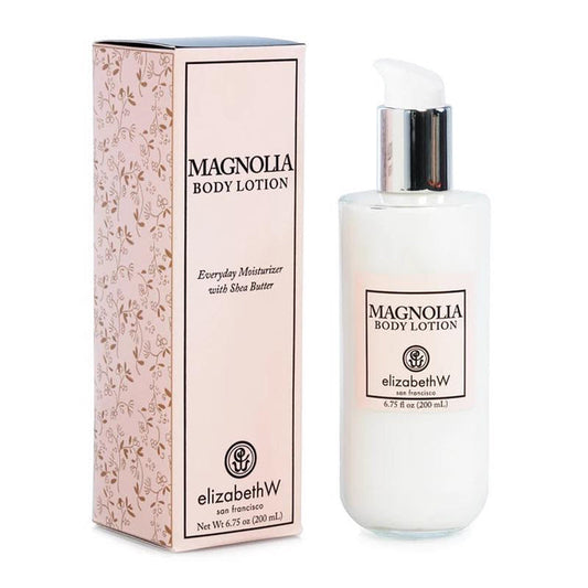 The image showcases a bottle of MAGNOLIA BODY LOTION by E WIGHTMAN & CO alongside its matching box. The bottle, featuring a pump dispenser, holds 6.75 fl oz (200 ml). Both the bottle and the box are branded with the name elizabethW San Francisco and describe the lotion as an everyday moisturizer enriched with shea butter and Vitamin E for additional hydration.