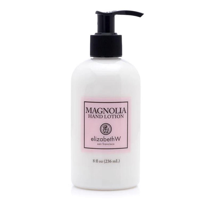 A white pump bottle labeled "MAGNOLIA HAND LOTION" by E WIGHTMAN & CO, 8 fl oz (236 mL), with a light pink and black label contains a hydrating lotion formula enriched with shea butter and vitamin E.