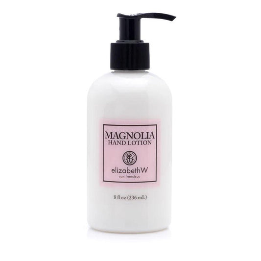 A white pump bottle labeled "MAGNOLIA HAND LOTION" by E WIGHTMAN & CO, 8 fl oz (236 mL), with a light pink and black label contains a hydrating lotion formula enriched with shea butter and vitamin E.
