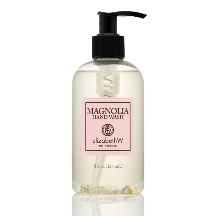 An 8 fl oz (236 mL) clear plastic pump bottle of MAGNOLIA HAND WASH by E WIGHTMAN & CO features a pink-bordered label with black text, offering an elegant botanical hand wash.