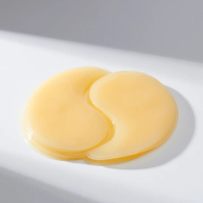 A white-background features a yellow container of EXOD INTERNATIONAL's MEDIHEAL - VITA COLLAGEN EYE AMPOULE PATCH 60PC, designed to enhance hydration and reduce eye wrinkles with its collagen-rich formula.
