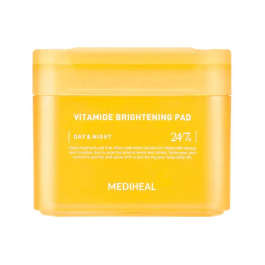 A yellow container labeled "VITAMIDE BRIGHTENING PAD 100PC" by EXOD INTERNATIONAL, infused with Sea Buckthorn for a luminous glow. The text includes "Day & Night" and "24/7." Minimalistic packaging with sleek white text promises that coveted glass skin.