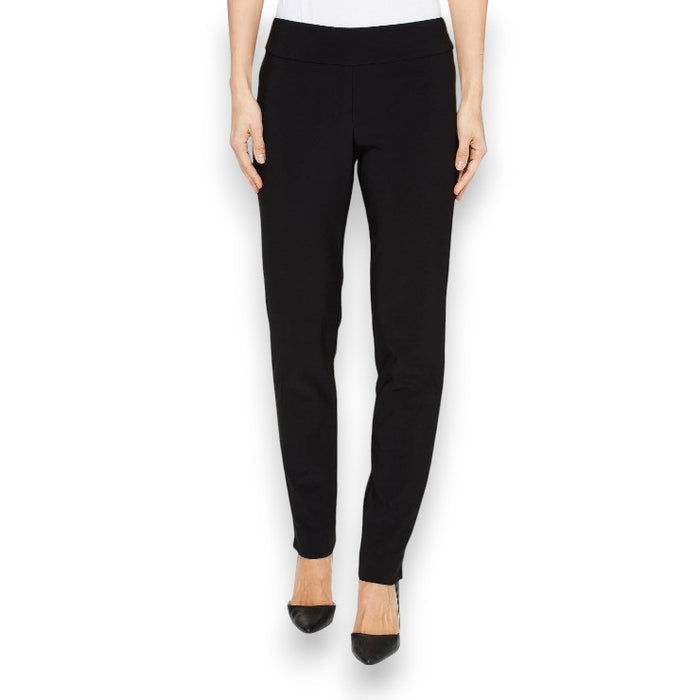 A person stands against a white background wearing KRAZY LARRY, INC.'s MICROFIBER PULL ON PANT - LONG in sleek black, complemented by high heels. The 32" inseam enhances the elegance and simplicity of their attire, as the top remains out of view.