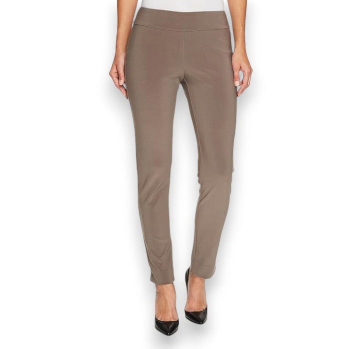 A person is wearing the MICROFIBER PULL ON PANT - LONG by KRAZY LARRY, INC in taupe microfiber and black pointed heels, standing against a plain white background. The pants have a fitted appearance, and the person's arms are cropped out of the image. Made in USA.