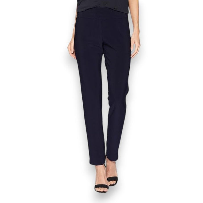 A person is showcased against a white background wearing KRAZY LARRY, INC's MICROFIBER PULL ON PANT - LONG in a high-waisted design paired with sleek black heeled sandals. Their top and arms are partially visible, contributing to an elegant silhouette.