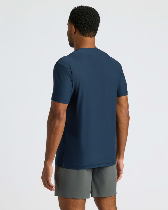 Man wearing Navy Active Crew Neck Tee and dark gray athletic shorts.