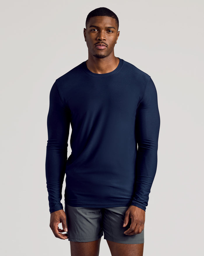 Young man in Navy Long Sleeve Tall Active Crew and gray shorts.