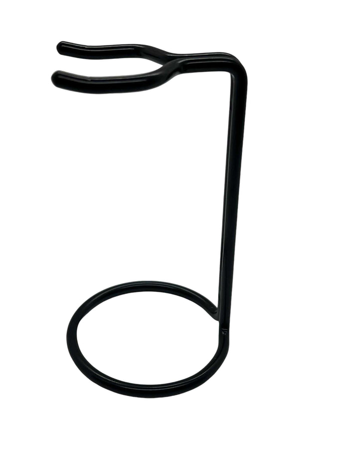 Close-up of black metal brush stand with hooks for grooming tools