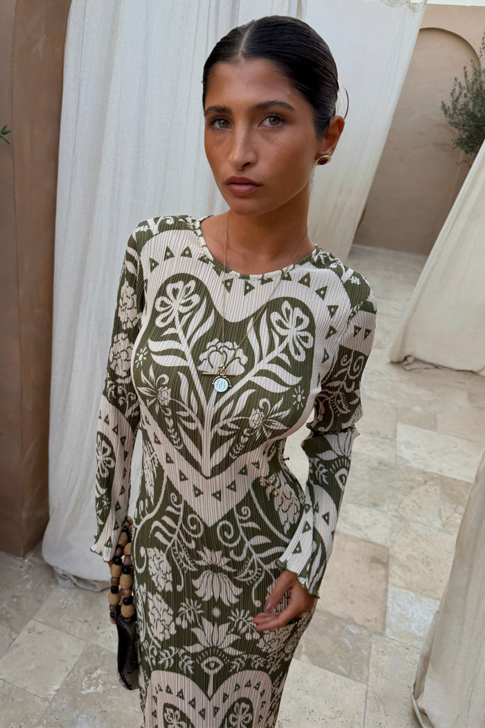 Olive Amara Plisse Gaia Dress with a green heart, eye and floral print in a stretchy, long-sleeved plisse style.