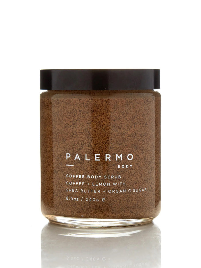 A clear jar with a black lid holds PALERMO BODY’s COFFEE & LEMON BODY SCRUB, an exfoliating sugar scrub with shea butter and organic sugar (8.5oz/240g). The brown, granular formula is a favorite for cellulite treatment.