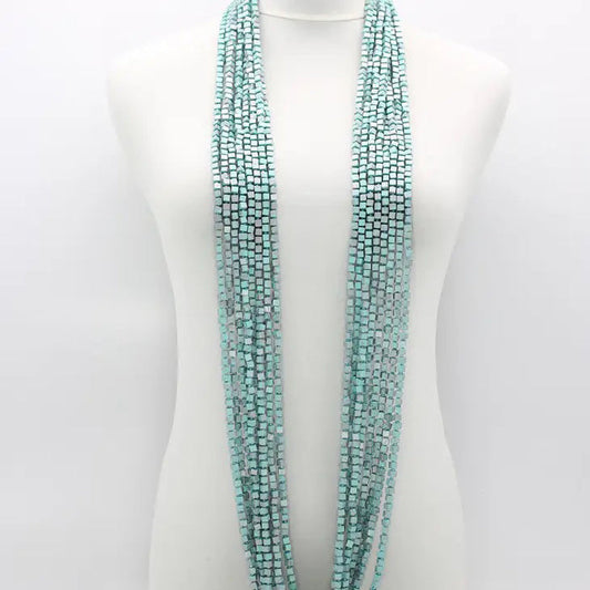 A mannequin displays the JIANHUI LONDON PASHMINA NECKLACE HAND PAINTED 10 STRAND, featuring vibrant, hand-painted wooden beads cascading elegantly around the neck.