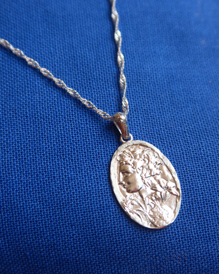 Silver oval pendant necklace of the Greek goddess Persephone, goddess of the spring and queen of the Underworld on a sterling silver 925 singapore twisted chain made in Greece. Greek mythology jewelry
