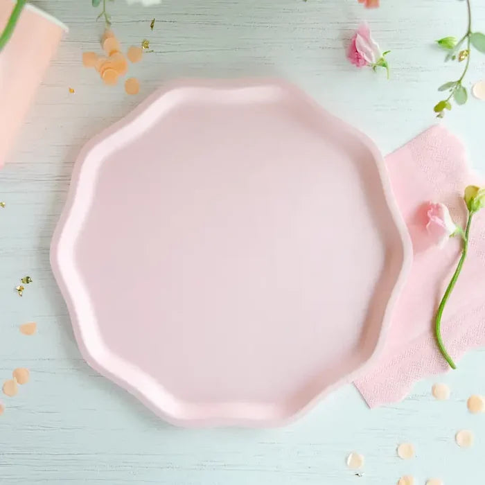 Pink octagonal plate on a light blue background with flowers and confetti.