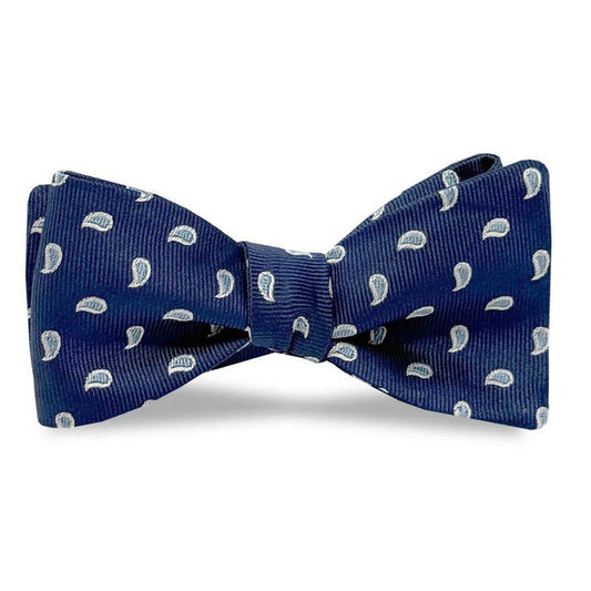 The BIRD DOG BAY PETER-BLAIR Cape Cod Silk Bow Tie in Navy features a white paisley pattern and comes unfastened for easy adjustment, offering elegance and comfort against a classic white background.