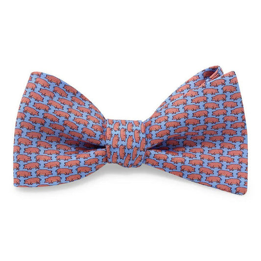 The BIRD DOG BAY PETER-BLAIR Tiny Swine Silk Bow Tie in Blue features a handmade design with small red pigs facing left on vibrant blue silk. Adjustable for a perfect fit.