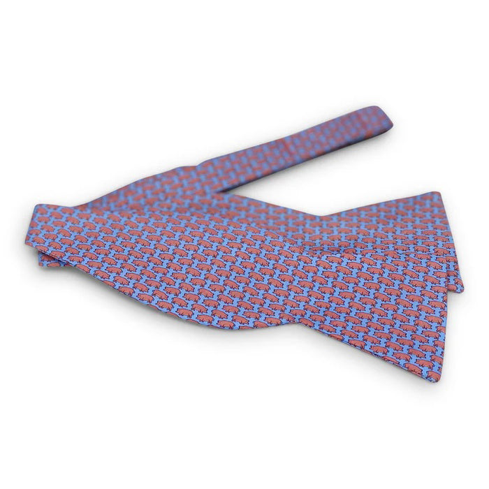 The BIRD DOG BAY PETER-BLAIR Tiny Swine Silk Bow Tie in Blue features a handmade design with small red pigs facing left on vibrant blue silk. Adjustable for a perfect fit.