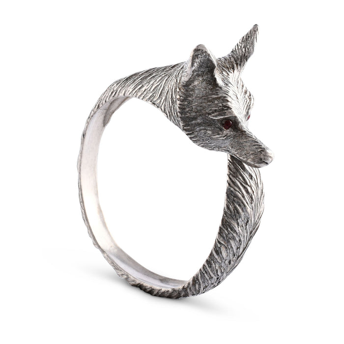 Silver napkin ring with a fox head design on a white background.