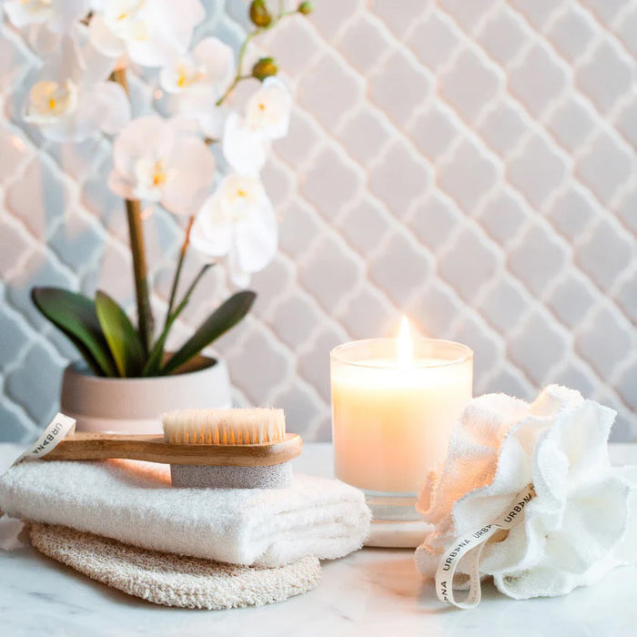 The EUROPEAN SOAPS, LLC PUMICE STONE WITH NAIL BRUSH features a wooden handle, natural bristles for nails, a pumice stone for exfoliation, and a looped fabric strap for easy use—ideal for smoothing and cleaning rough skin.