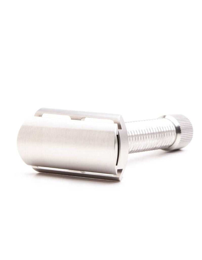 Stainless steel safety razor with a sleek, cylindrical handle and a closed comb head, designed for close, smooth shaves.