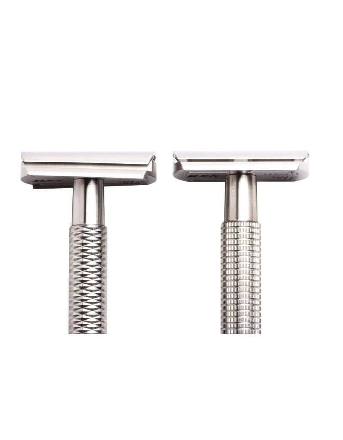 Two stainless steel safety razors with textured handles and open comb heads, ideal for precision shaving and grooming.