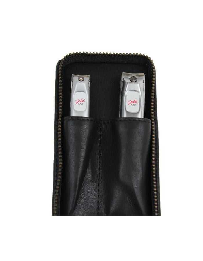 Closed black leather grooming kit with two stainless steel nail clippers inside