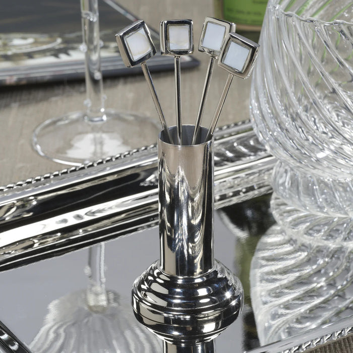 The ZODAX SPIGA Set of 4 Cocktail Picks with Stand features sleek metal picks with square mother of pearl tops in a metallic holder with round base. Ideal for stylish home bars. Set photographed on a plain white background.