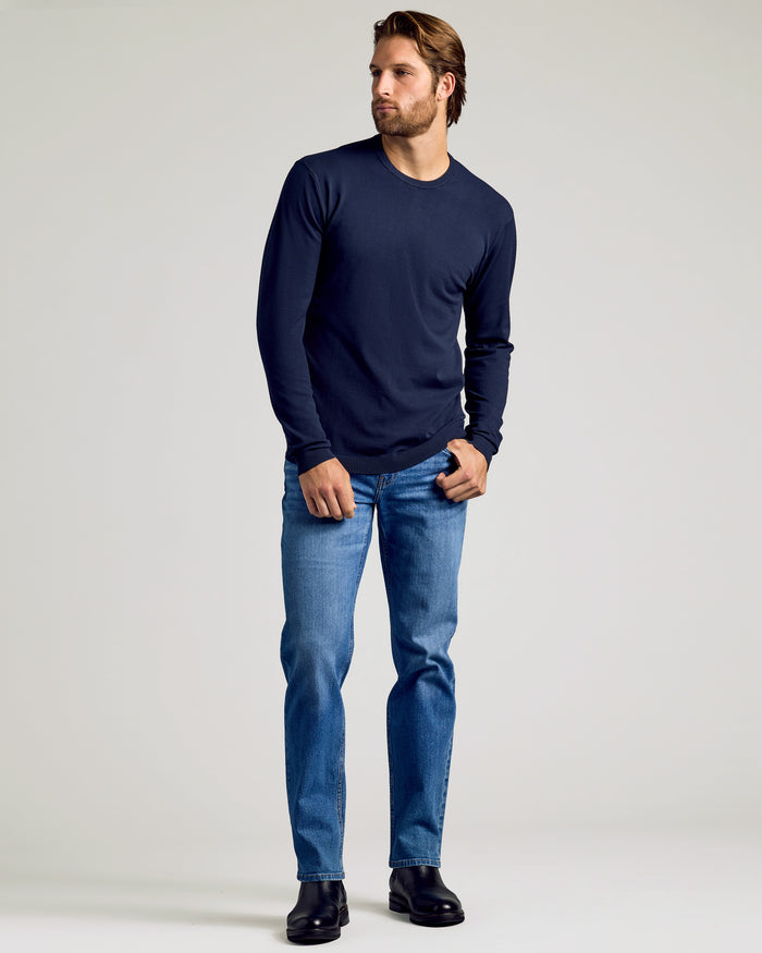 Man wearing Staple Crew Neck Sweater 3-Pack, jeans, black boots.