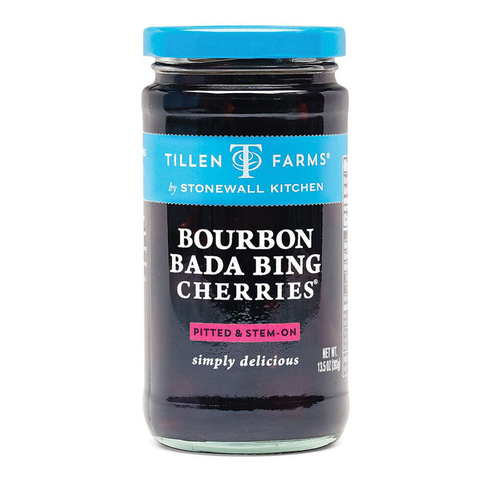 A jar of Stonewall Kitchen Bourbon Bada Bing Cherries. The label highlights these bourbon cocktail cherries are pitted and stem-on, and notes they are "simply delicious." The jar contains a net weight of 13.5 oz (383g).