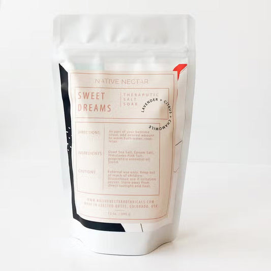 A white resealable pouch of NATIVE NECTAR SWEET DREAMS SALT SOAK features a pale pink label with product details, directions, and ingredients. Contains lavender, chamomile, and Dead Sea salts for a soothing bath experience.