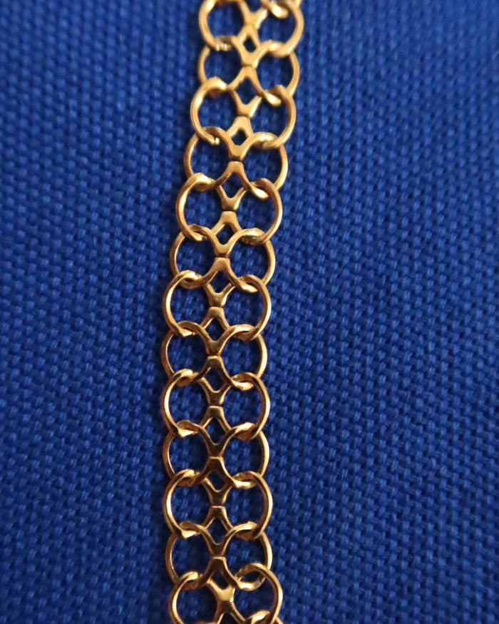 Gold chain on a blue textured background
