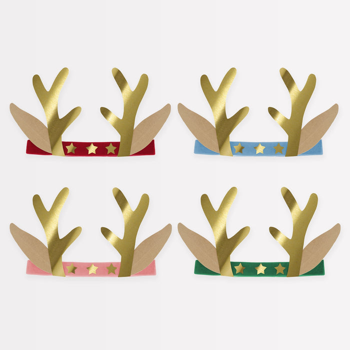 Set of four paper reindeer antlers with colorful bands on a white background