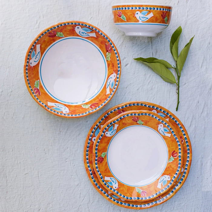 The VIETRI Melamine Campagna Dinner Plate features a round white center, an orange border with blue and white birds, red tulips, and green leaves—ideal for al fresco dining.