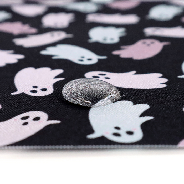 This printed WPC-Lite has ghosts that are featured in hues of pink and mint. This photo shows a water drop on the fabric.