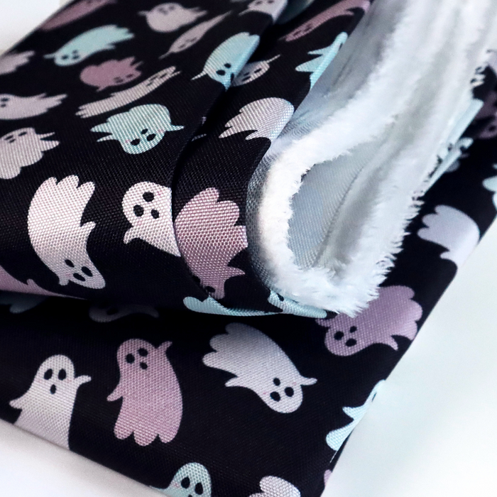 This printed WPC-Lite has ghosts that are featured in hues of pink and mint. This photo shows the fabric folded.