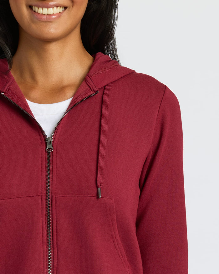 Womens Dark Maroon Crop Zip Hoodie, white T-shirt visible, slight smile.