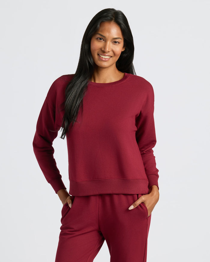 Woman wearing Womens Dark Maroon Slouch Pullover Crew, smiling with hands in pockets. MODEL_INFO: Candy is 5'9", wearing a size S