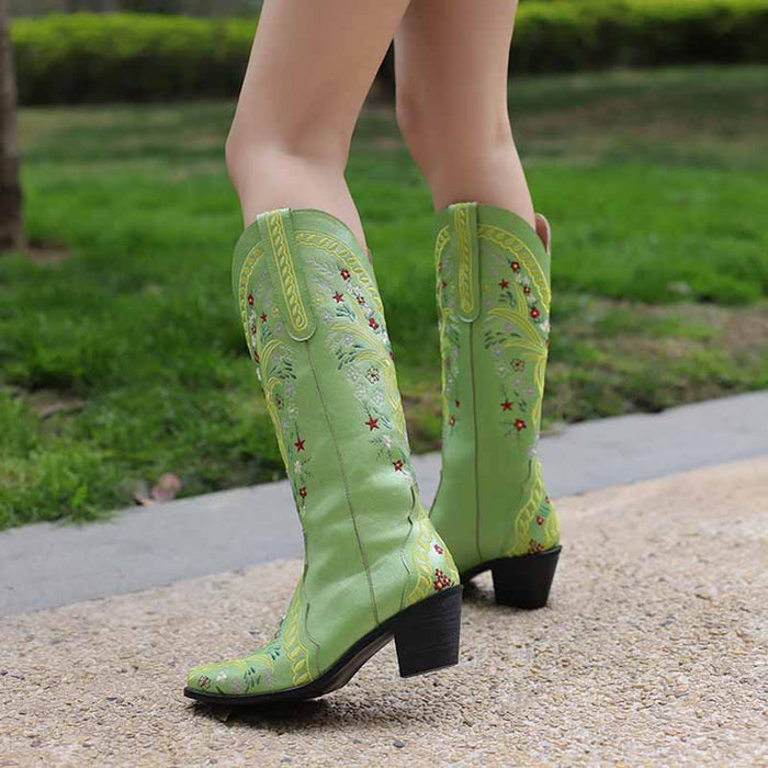 Stylish women's knee length cowgirl boots in green with floral embroidery and a chunky heel