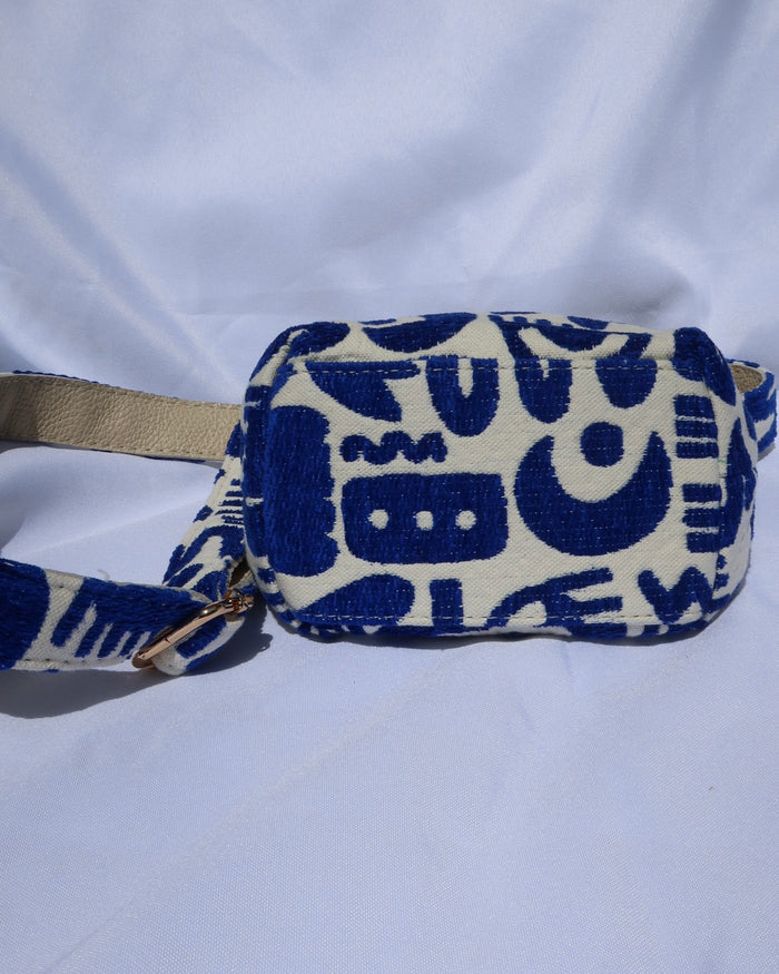Cream and royal blue bucket bag with geometric shapes and a leather drawstring with an adjusble crossbody strap made in Greece. Moons, hearts, evil eye print