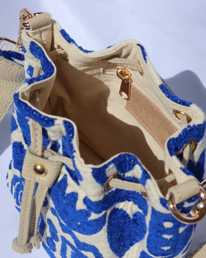 interior of Cream and royal blue bucket bag with geometric shapes and a leather drawstring with an adjusble crossbody strap made in Greece