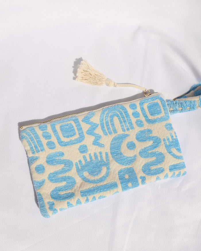 Woven cotton clutch bag wristlet with turquoise geometric print featuring evil eyes, rainbows, snakes, moons, and more made in Greece. Greek fashion accessory zipper pouch with tassel