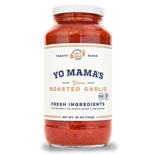 A 25 oz (708g) glass jar of YO MAMA'S FOODS ROASTED GARLIC SAUCE with a white label displaying the brand, flavor, keto certified, no sugar added, ingredients highlight; red sauce visible through the jar.
